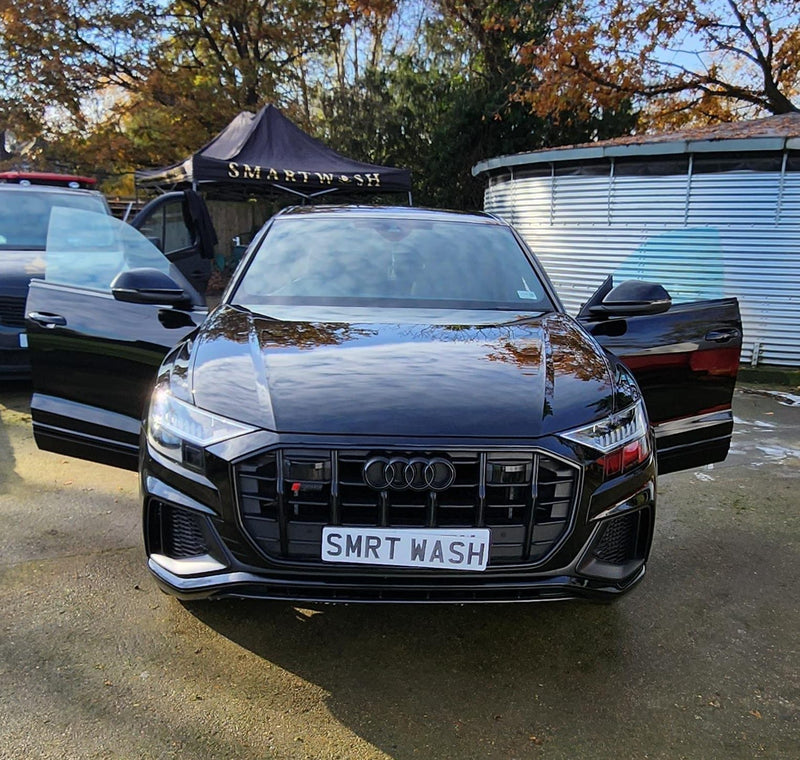 Black Audi SUV gleaming after a SmartWash