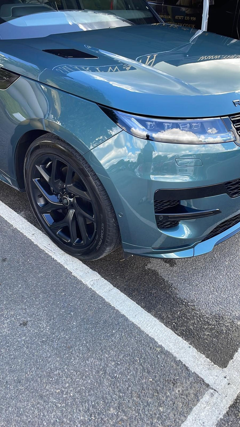 Blue Range Rover with a mirror finish after a wash