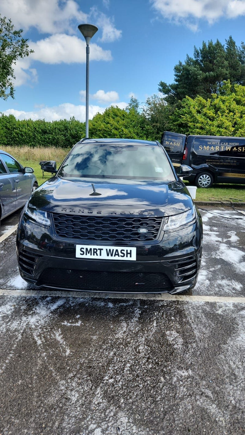 Black Range Rover mid-wash with the SmartWash van behind